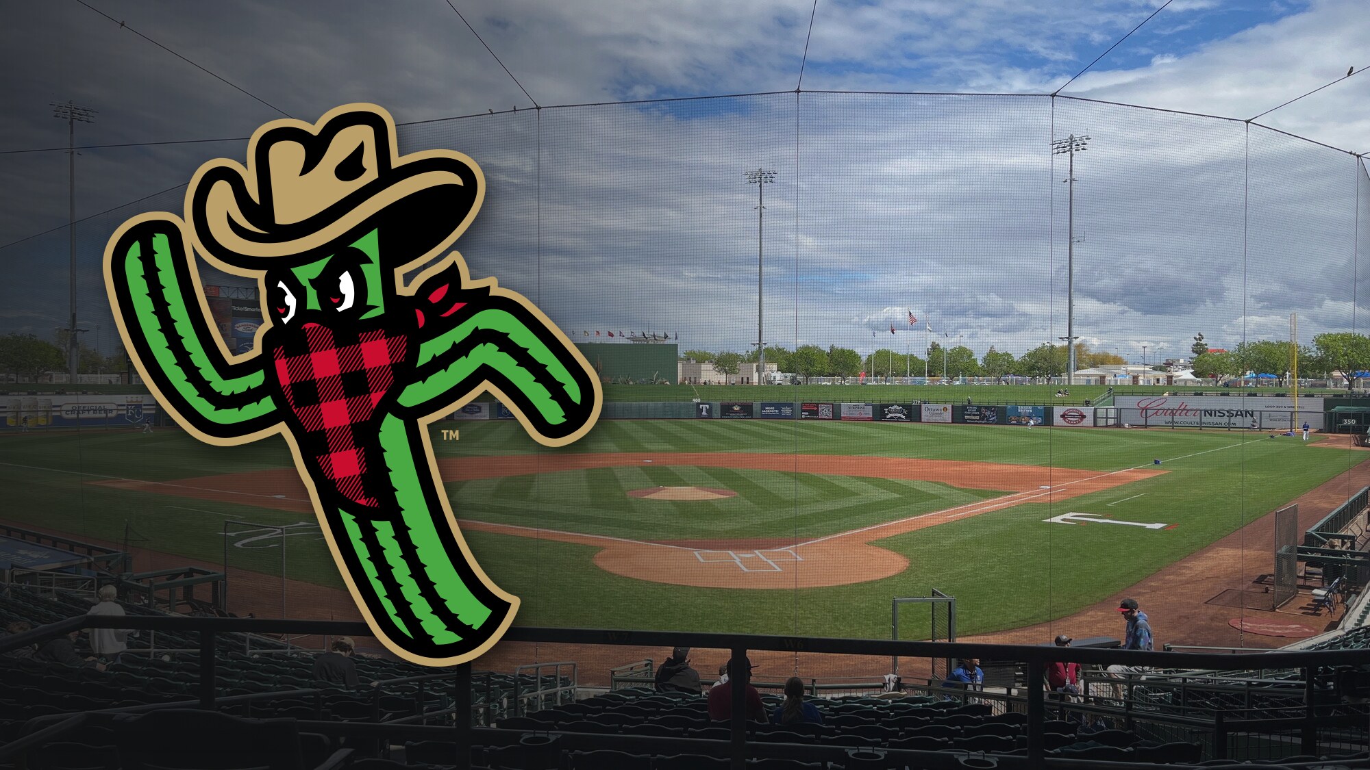 The Surprise Saguaros logo, a cactus in a cowboy hat and a red plaid bandana, over a view of the field at Surprise Stadium from the seats behind home plate.
