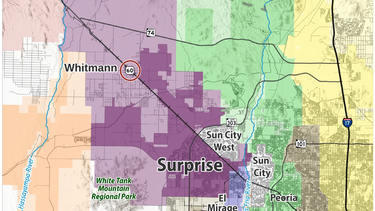 Map of the northwest Valley showing Surprise city limits in dark purple and the larger Surprise planning area in light purple. A red ring marks Whitmann, on U.S. 60 northwest of the city, inside the planning area.